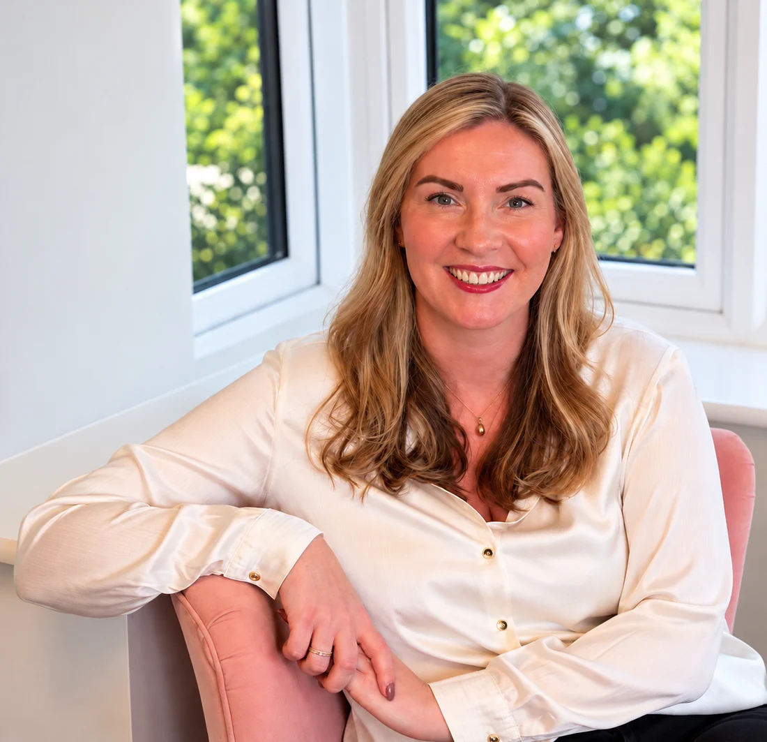 Caroline Lambe, founder of Wild Owl, sitting by a window